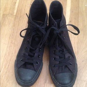 All black high top Converse/Chuck Taylors
